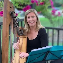 Lucia McGinnis teaching at the harp