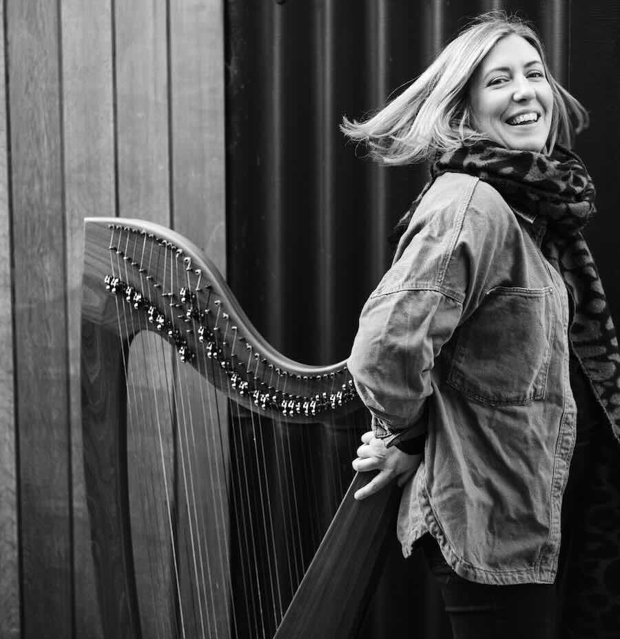 Lucia McGinnis playing a lever harp